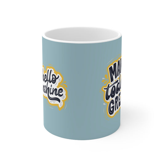 a blue coffee mug with a yellow and white design