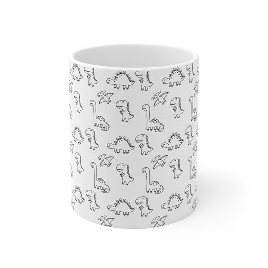 Front view of Mug showing wrap around pattern of black and white cartoon dinosaurs