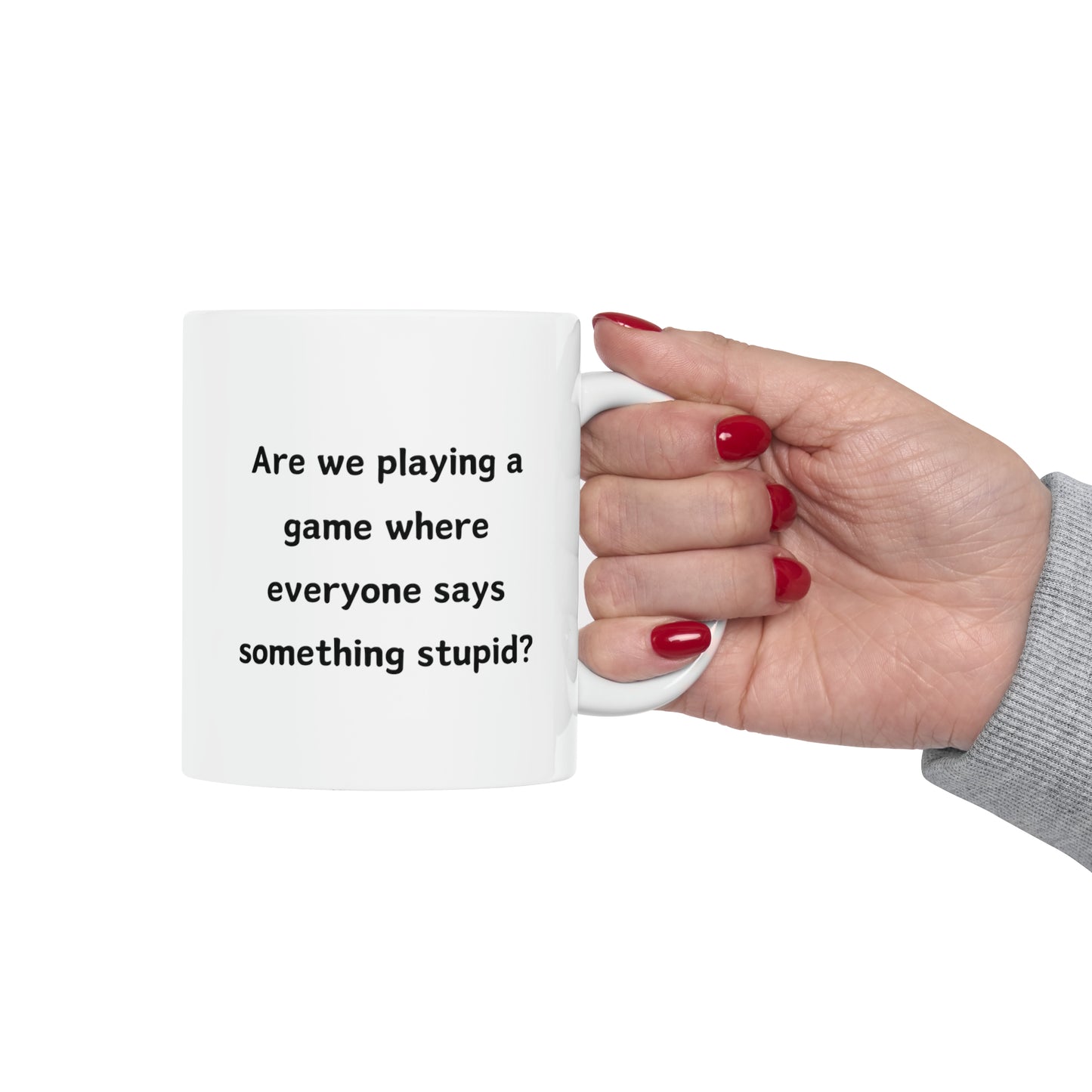 a woman's hand holding a coffee mug that says are we playing a game