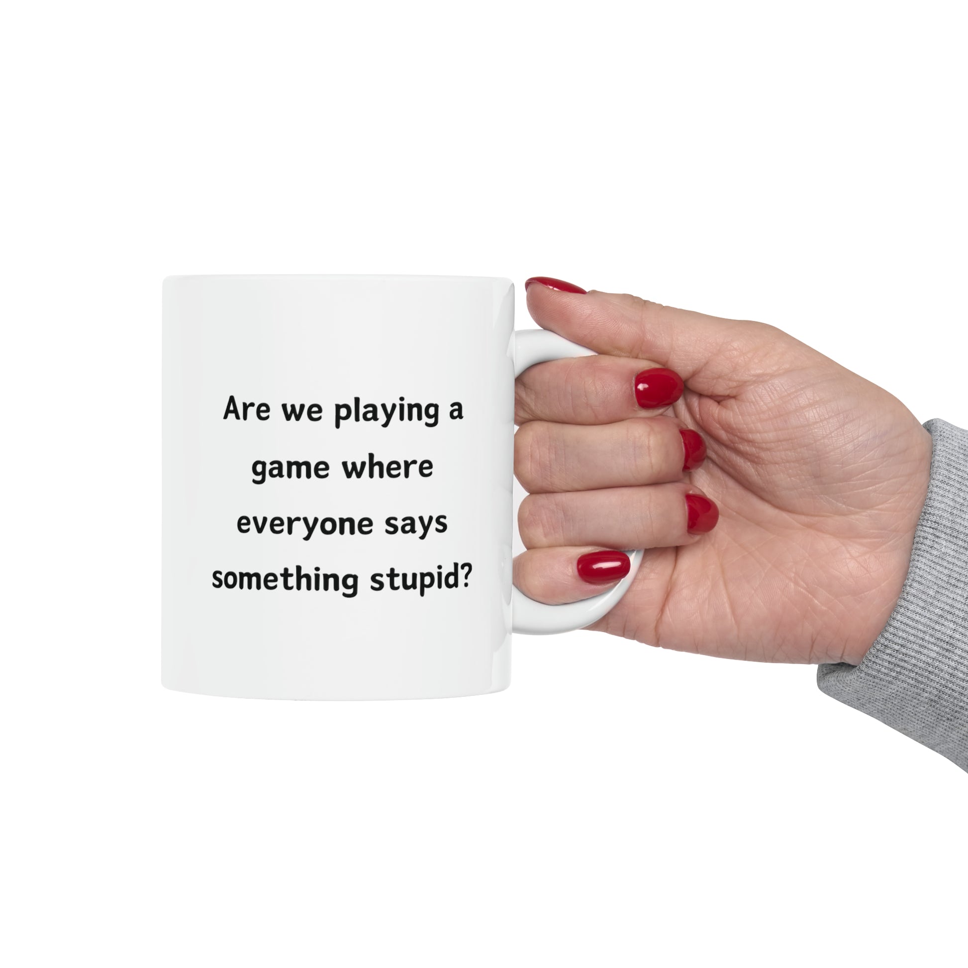 a woman's hand holding a coffee mug that says are we playing a game