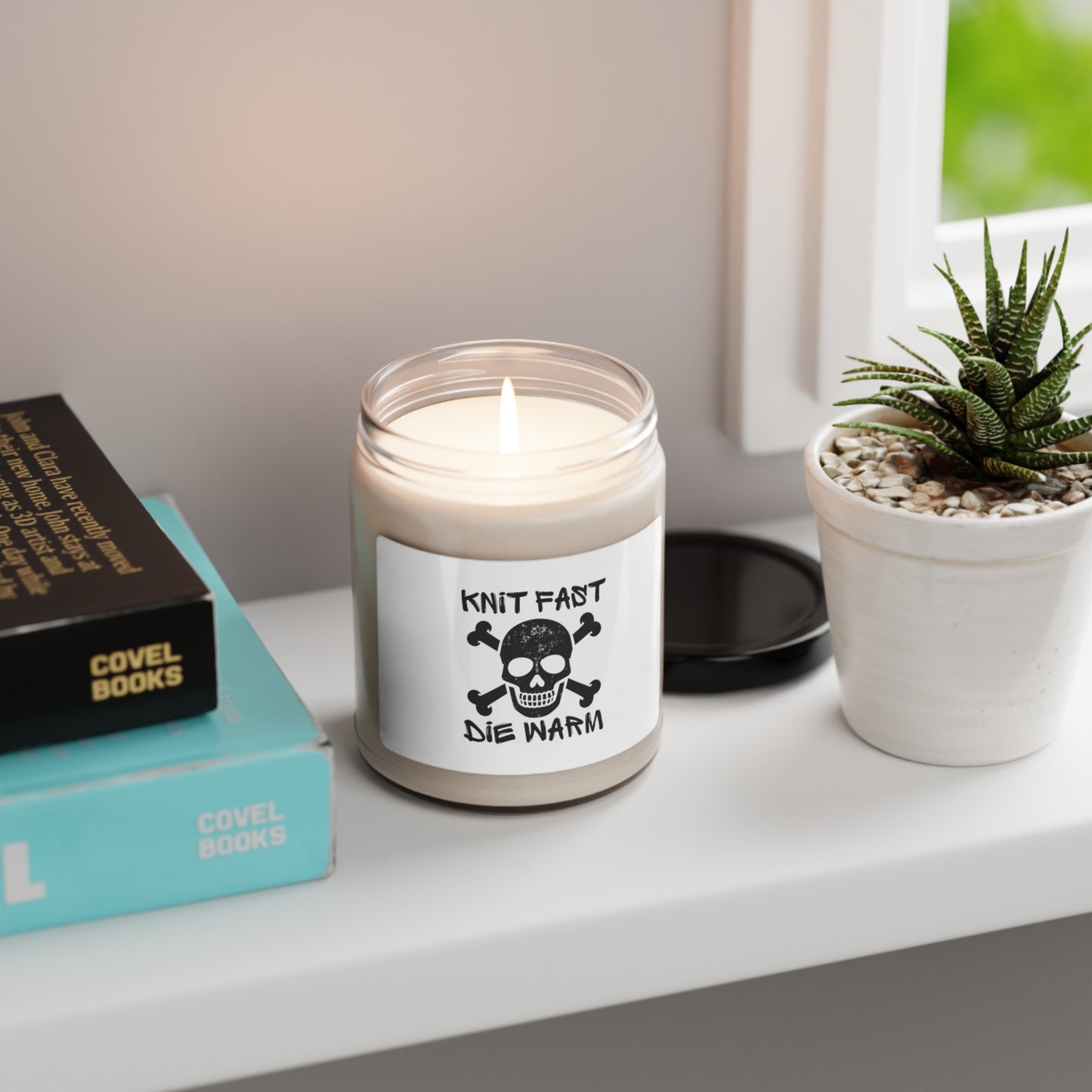 a candle sitting on top of a table next to a book